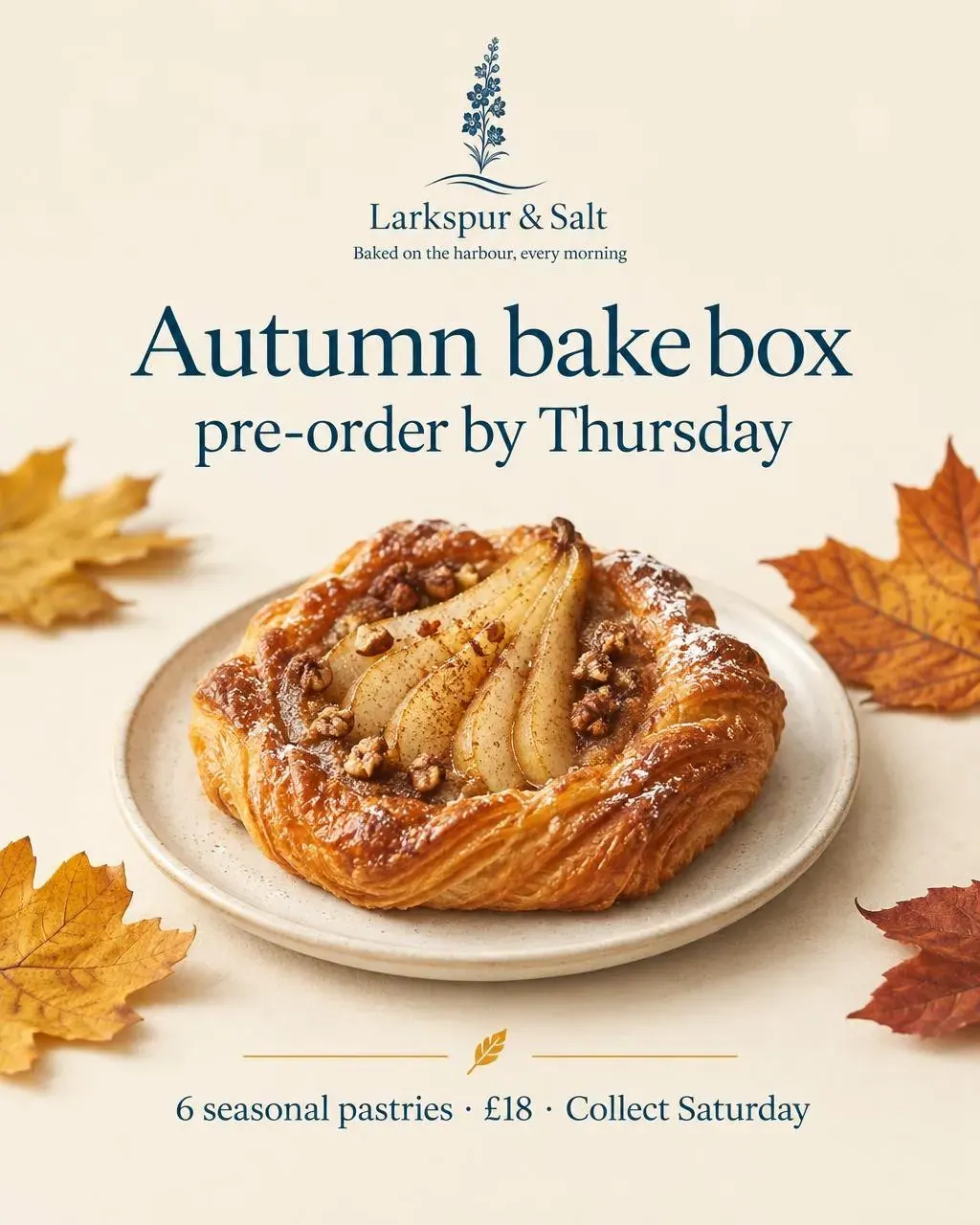 A cream promo card for the Autumn bake box with a pear danish on a plate and autumn leaves